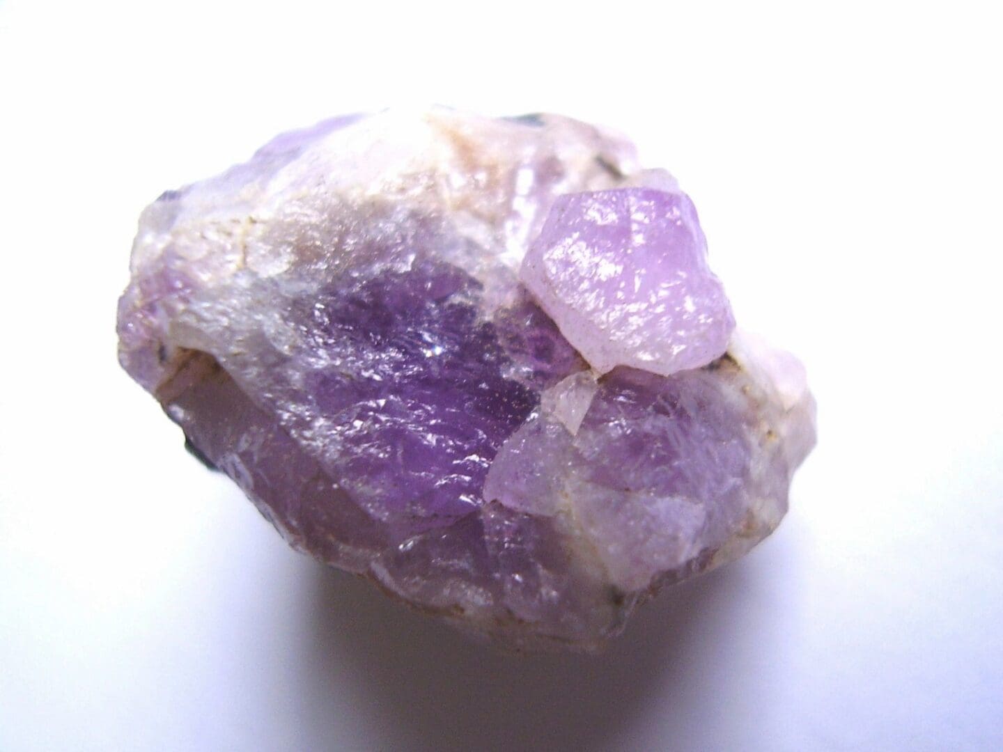 A purple rock with some kind of substance on it