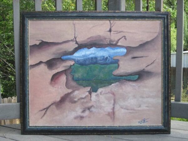 A painting of a tree in the middle of a crack.